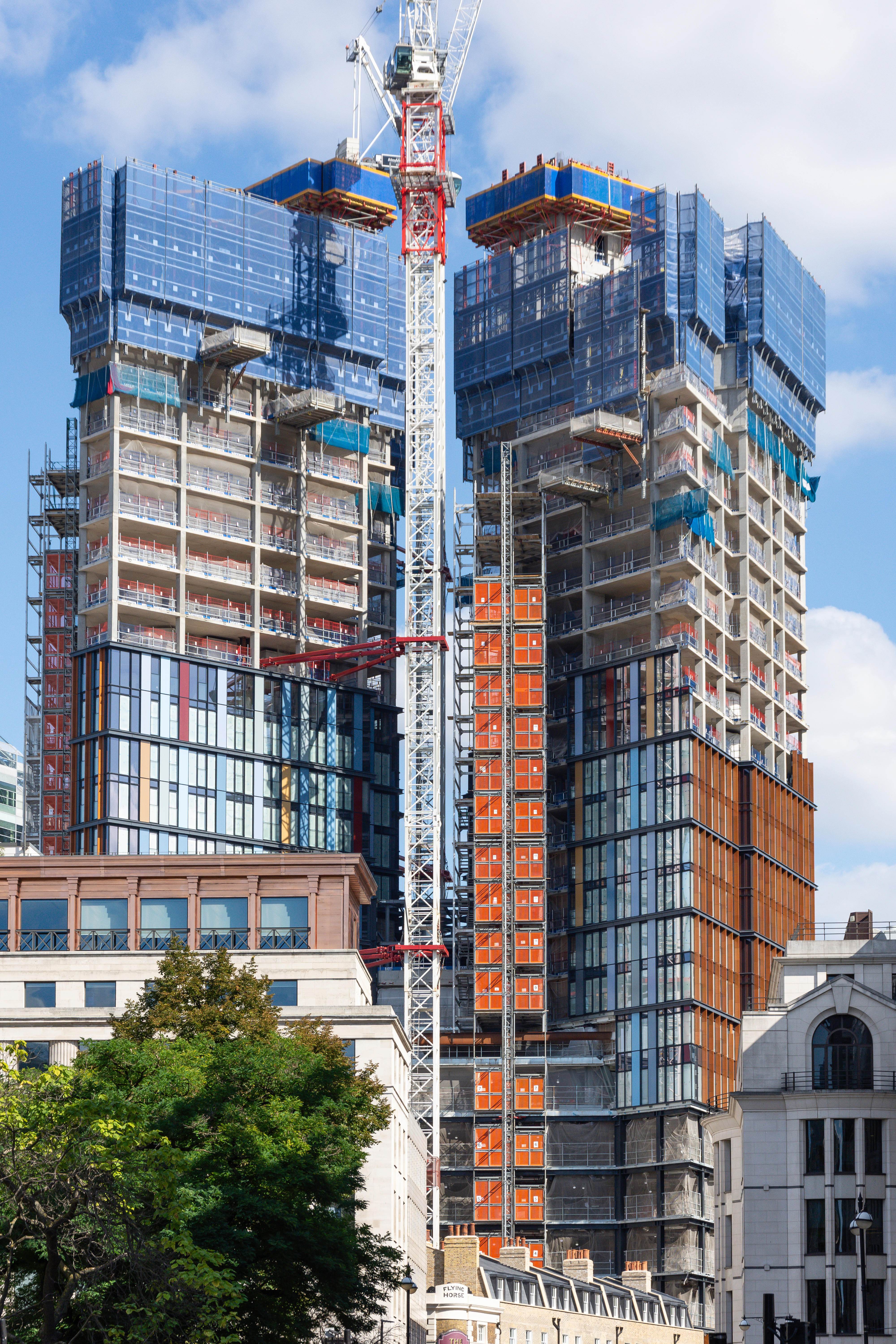 Large-scale urban construction site with multiple high-rise buildings under development, showcasing OJ Building Services expertise in complex construction projects
